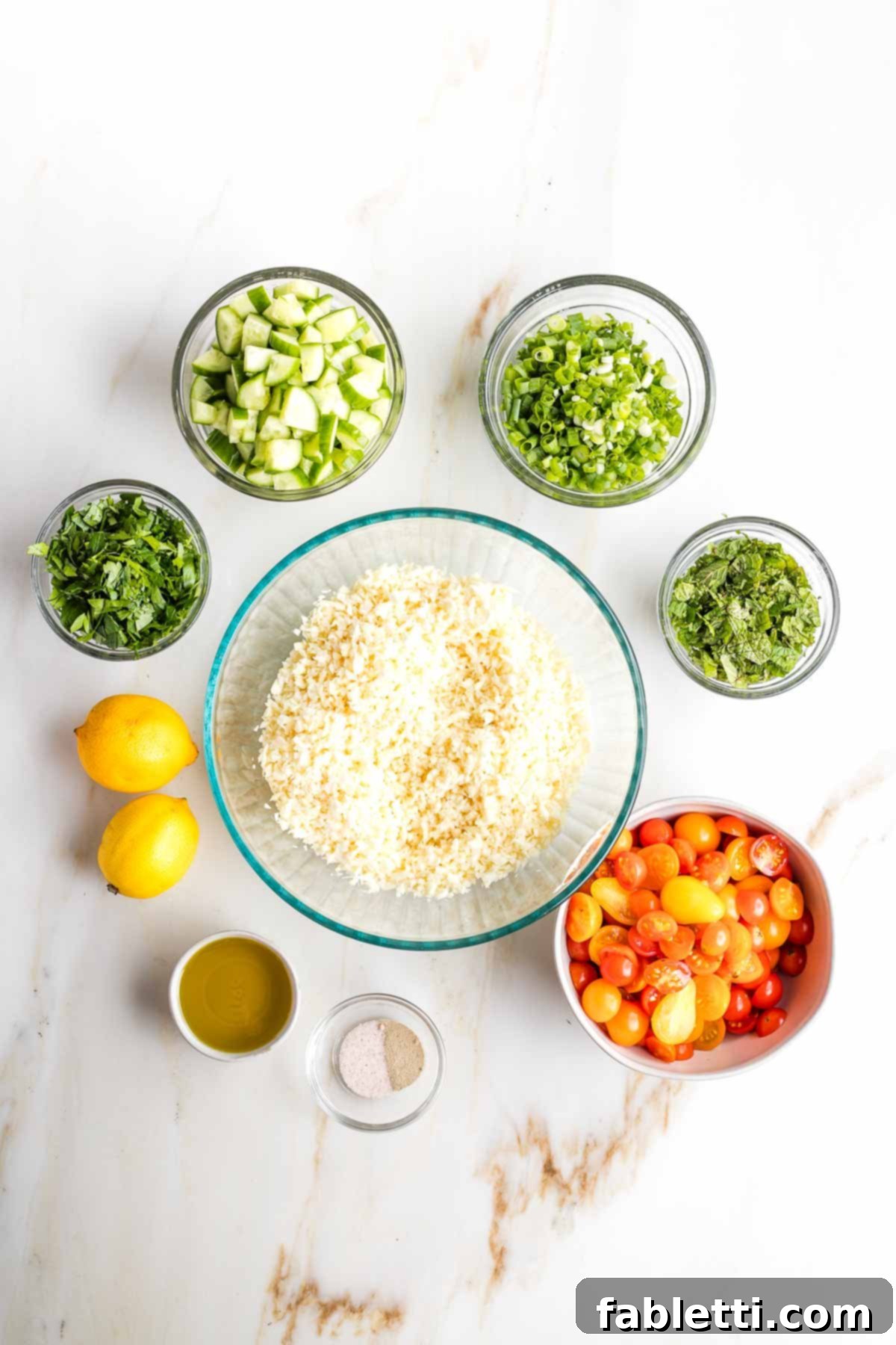 Sweet Parsnip Gluten-Free Tabbouleh 11 Large bowl of riced parsnips, surrounded by small bowls of chopped ingredients plus two lemons and dish of olive oil.
