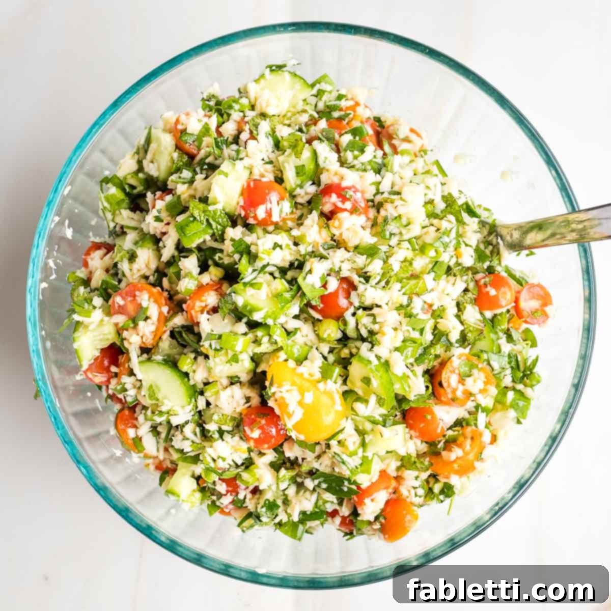Sweet Parsnip Gluten-Free Tabbouleh 14 Tabbouleh salad with bright colorful tomatoes, green herbs and cucumbers and little pieces of riced parsnips.