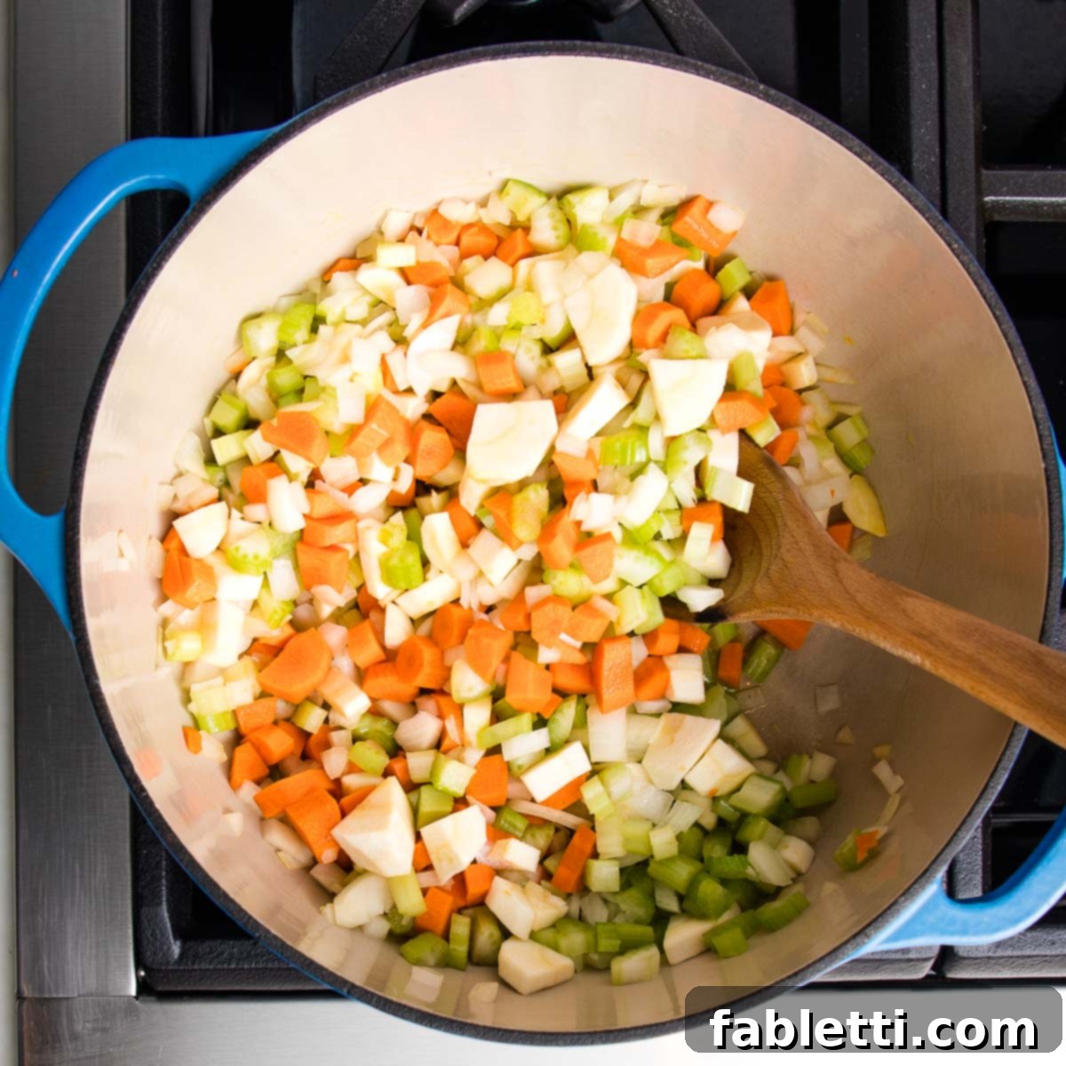 Wholesome Plant-Based Lentil Soup 7 Sautéing chopped vegetables in a Dutch oven.