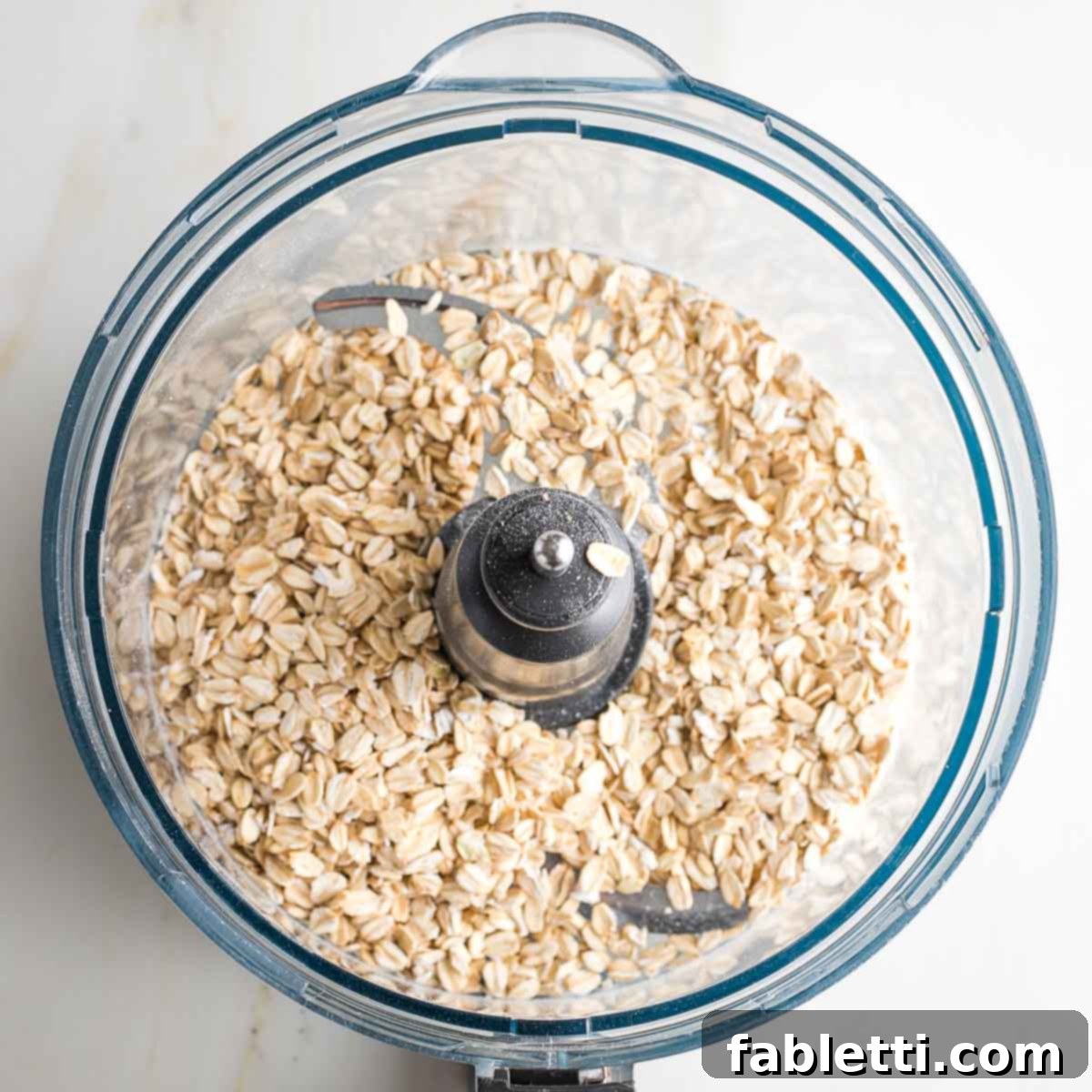 Old fashioned oats in a food processor bowl.