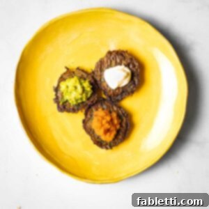 Oven-Baked Crispy Brussels Sprout Latkes 14 Crispy Brussels Sprouts Latkes with various toppings like applesauce, guacamole, and sour cream.