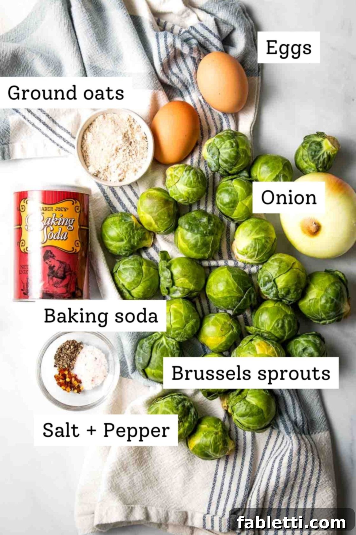 Oven-Baked Crispy Brussels Sprout Latkes 3 Carefully arranged ingredients for Brussels sprouts latkes: fresh Brussels sprouts, baking soda, eggs, ground oats, salt and pepper, and a sweet onion.