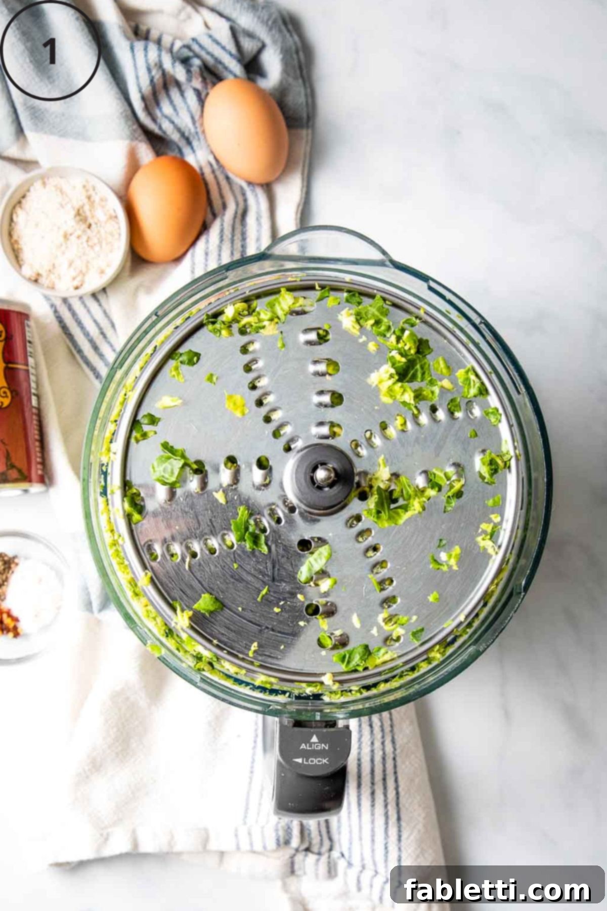 Oven-Baked Crispy Brussels Sprout Latkes 4 The shredding disc of a food processor, after efficiently shredding fresh Brussels sprouts to the perfect texture for latkes.