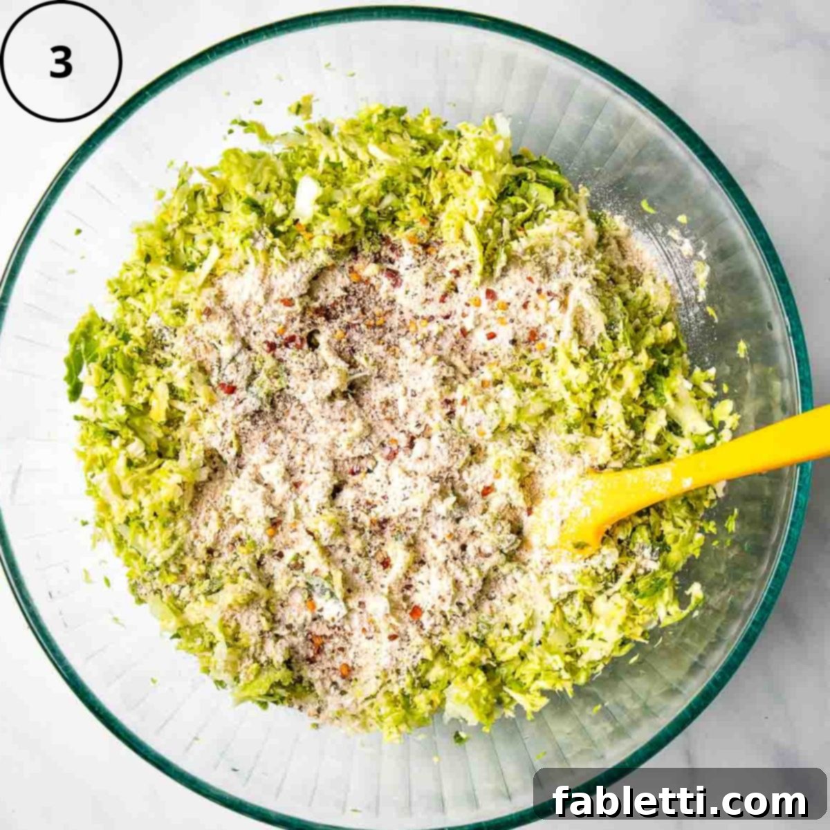 Oven-Baked Crispy Brussels Sprout Latkes 6 Shredded Brussels sprouts and onions in a bowl, generously topped with ground oat flour and a medley of savory spices.