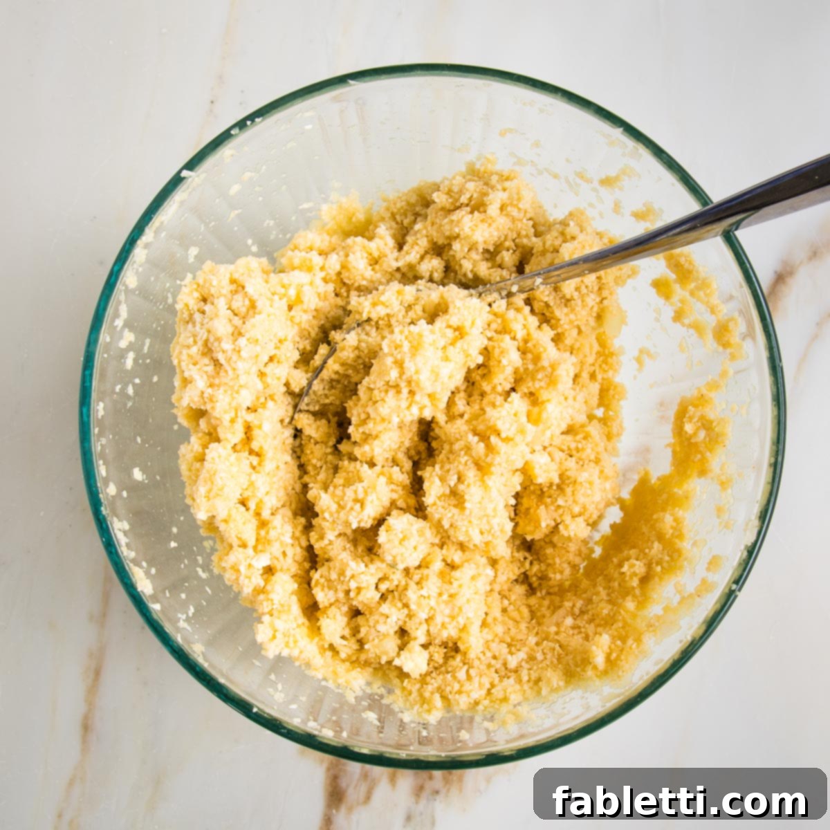 Flavorful Cauliflower Onion Buns 6 A large glass bowl containing a fully mixed cauliflower roll batter, showing its cohesive and ready-to-form consistency.