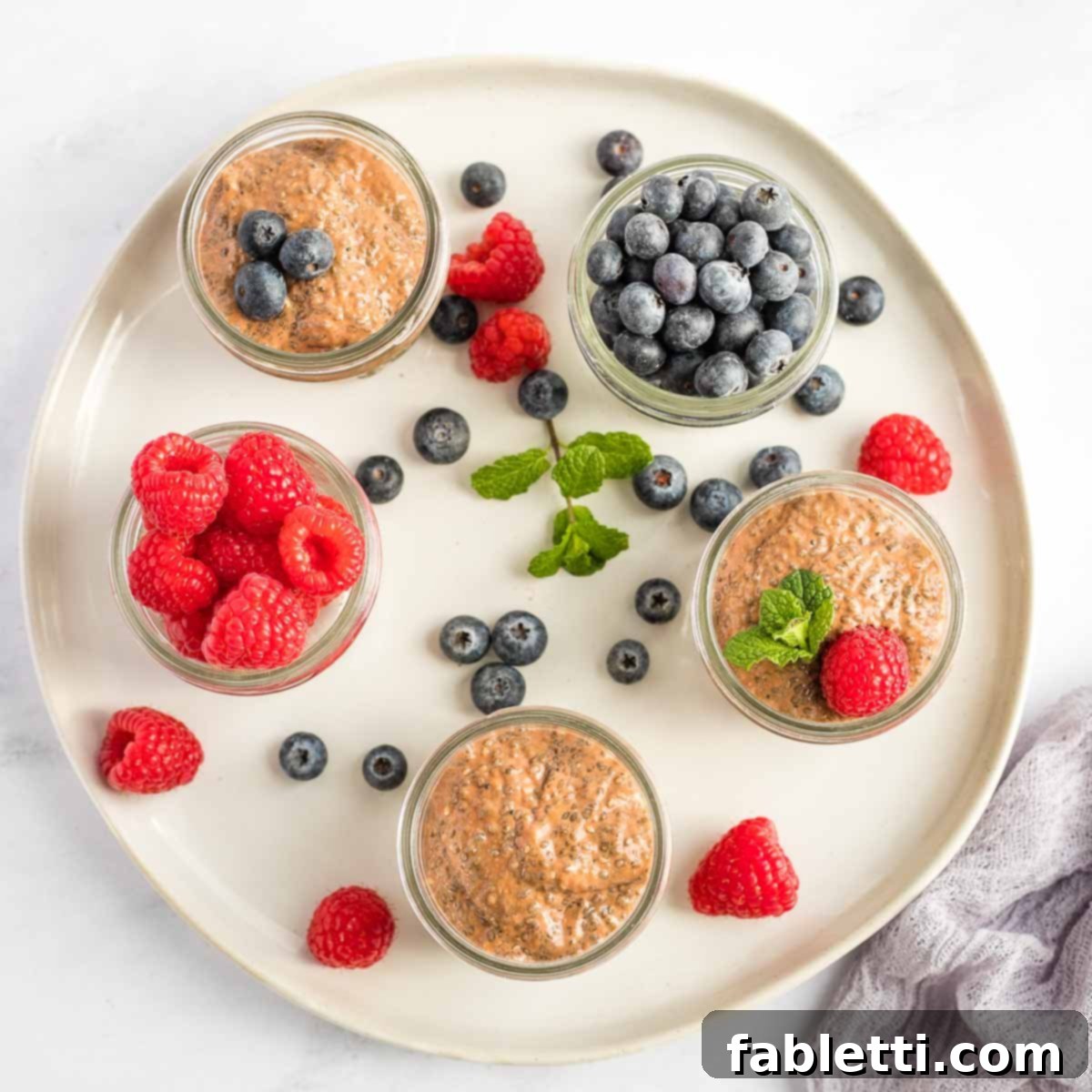 Effortless Chocolate Chia Pudding Bliss 14 Small mason jars with chocolate chia pudding. Some with fresh berries too.
