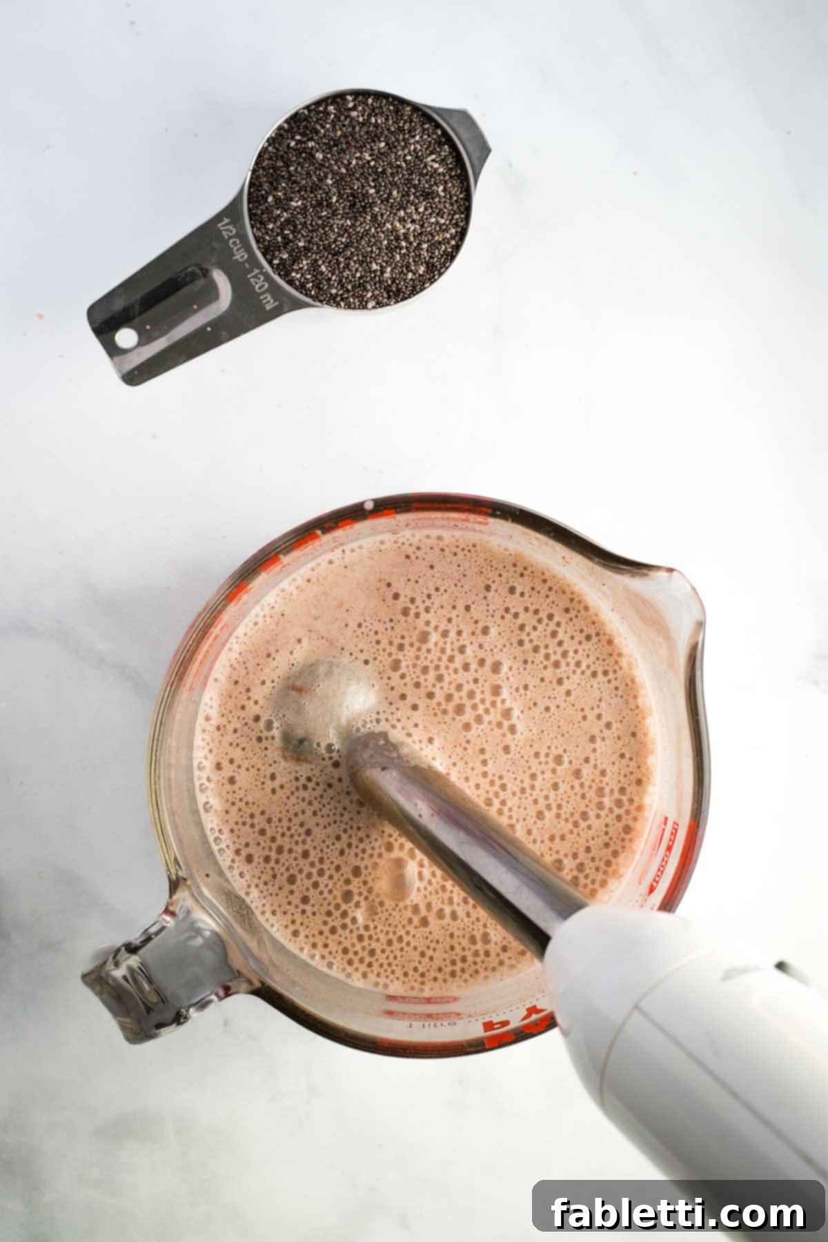 Effortless Chocolate Chia Pudding Bliss 7 Making vegan chocolate milk with an immersion blender to become chia pudding.