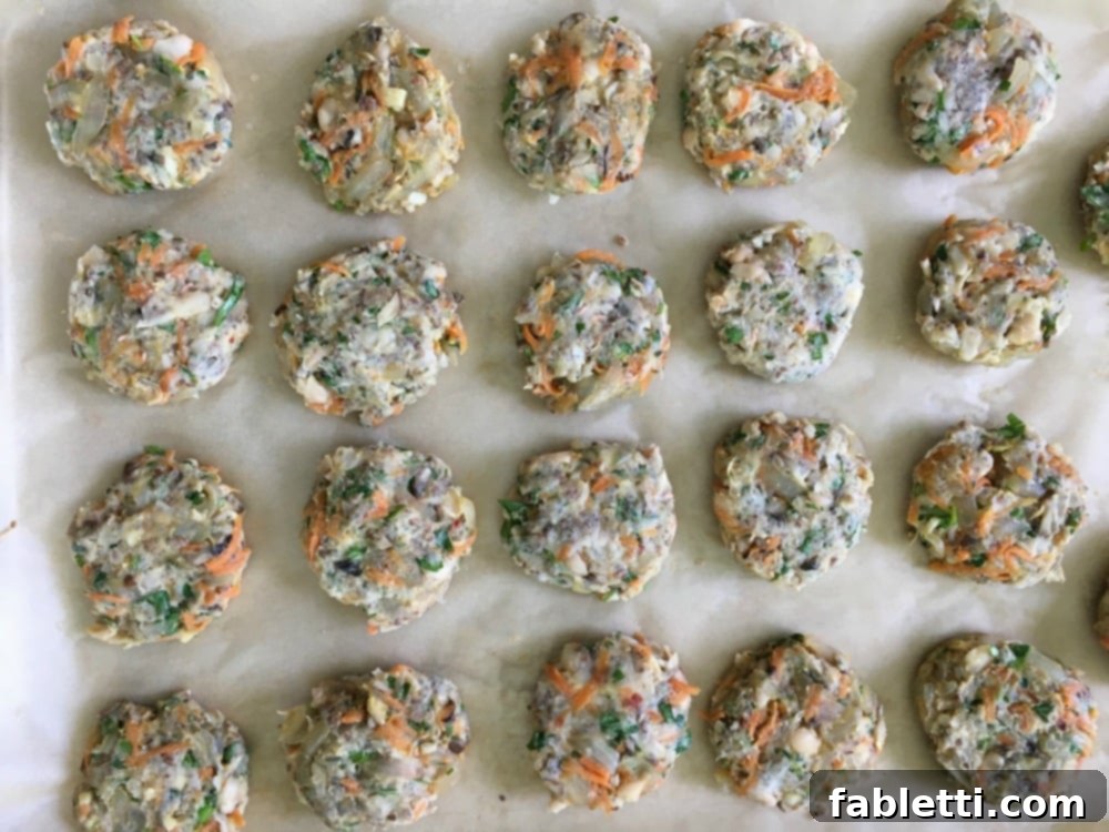 Hearty Homemade White Bean Veggie Burgers 14 A baking tray filled with numerous mini white bean burgers, perfectly portioned and ready to be baked into delicious appetizer sliders.