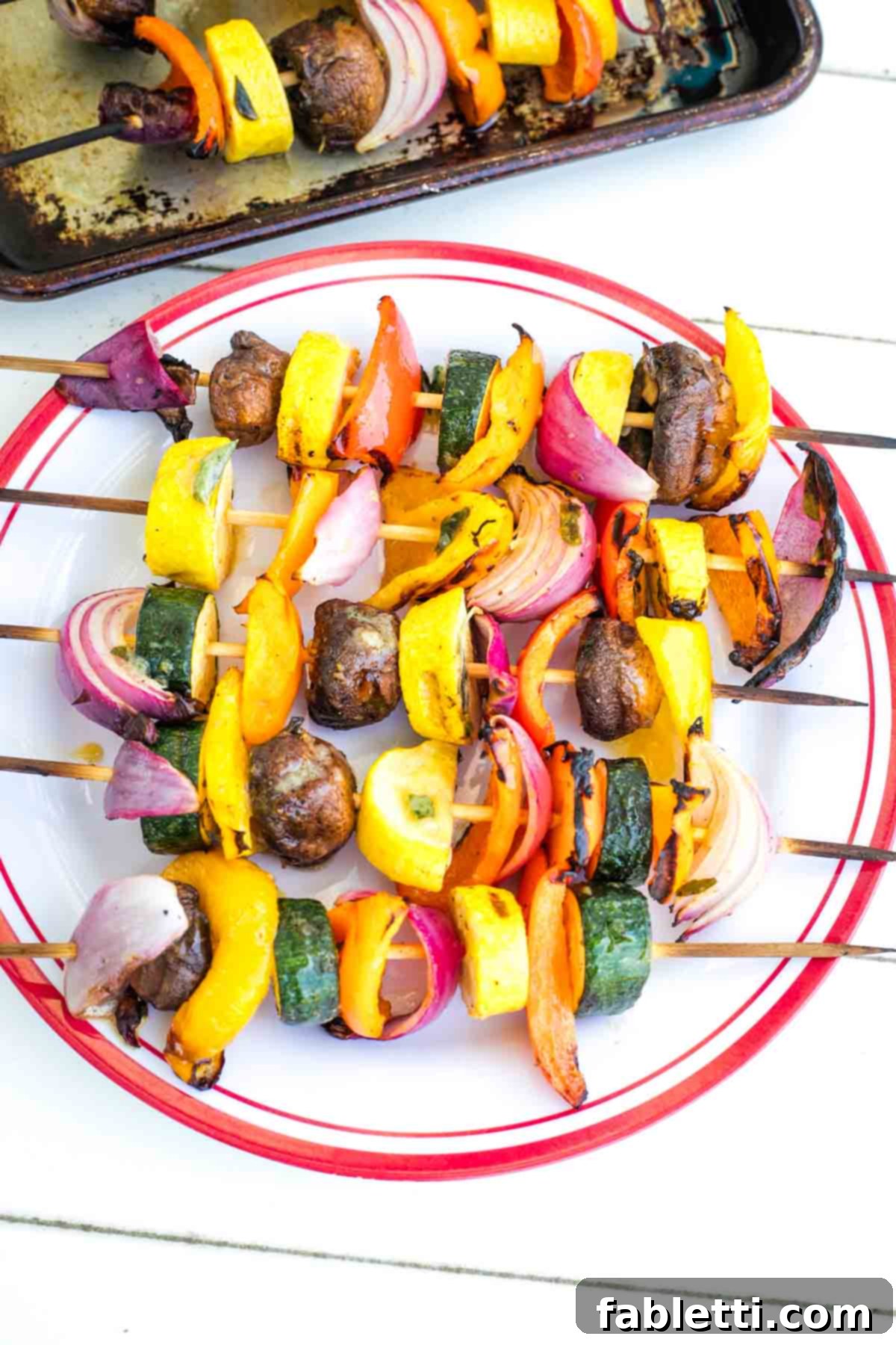 Vibrant Mediterranean Veggie Skewers 2 Close-up of colorful grilled vegetable skewers on a platter, showcasing vibrant bell peppers, zucchini, onions, and mushrooms with char marks.