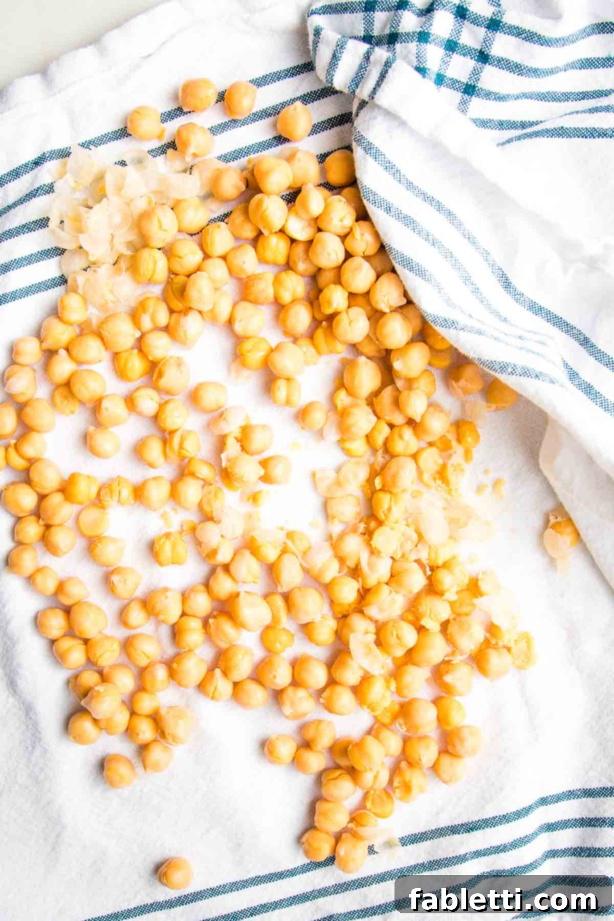 Decadent Vegan Gluten-Free Chocolate Chunk Skillet Cookie 4 A kitchen dish towel is used to gently rub chickpeas dry, dislodging their skins for a smoother cookie dough.