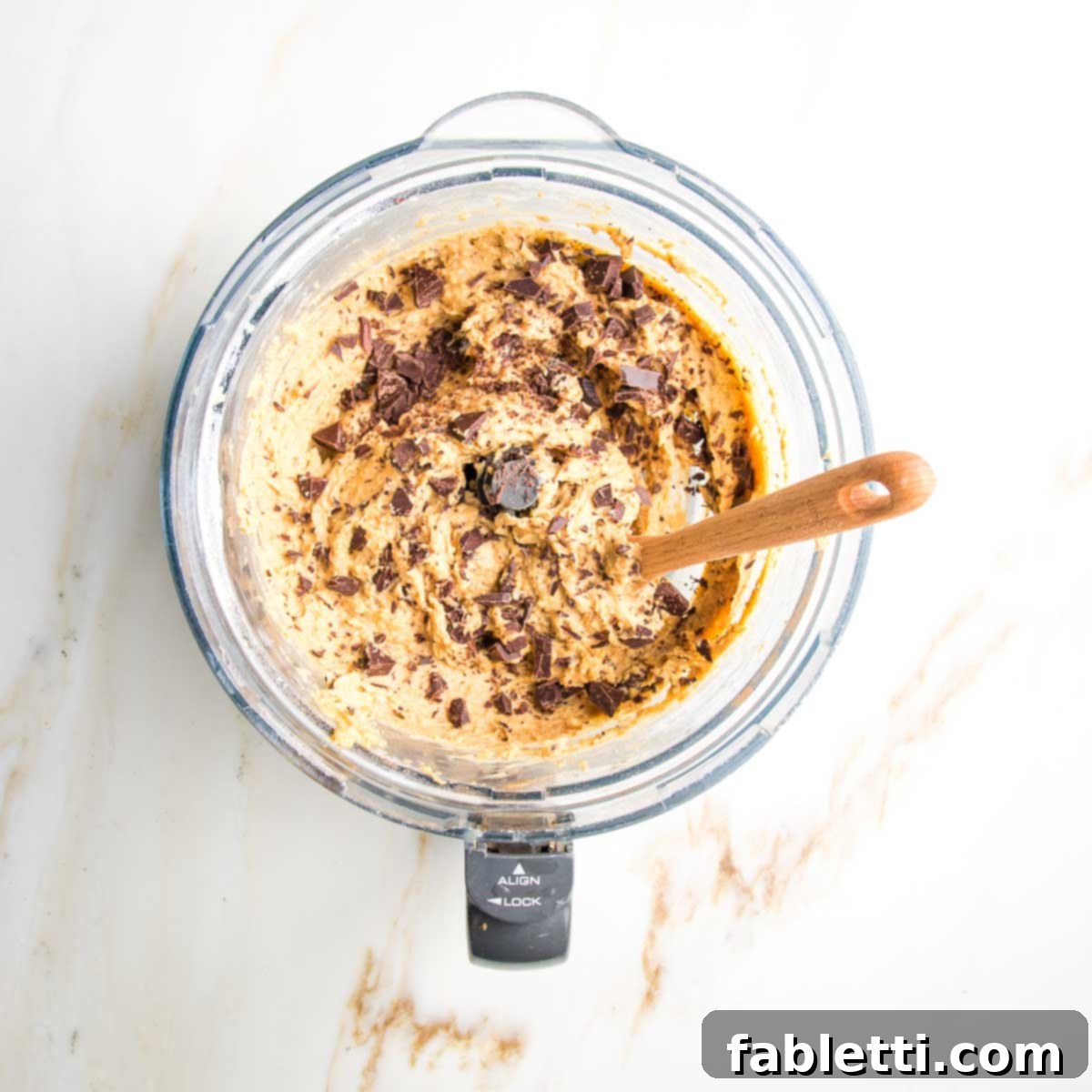 Decadent Vegan Gluten-Free Chocolate Chunk Skillet Cookie 8 Rich chocolate chunks are gently mixed into the smooth cookie dough batter in the food processor bowl.