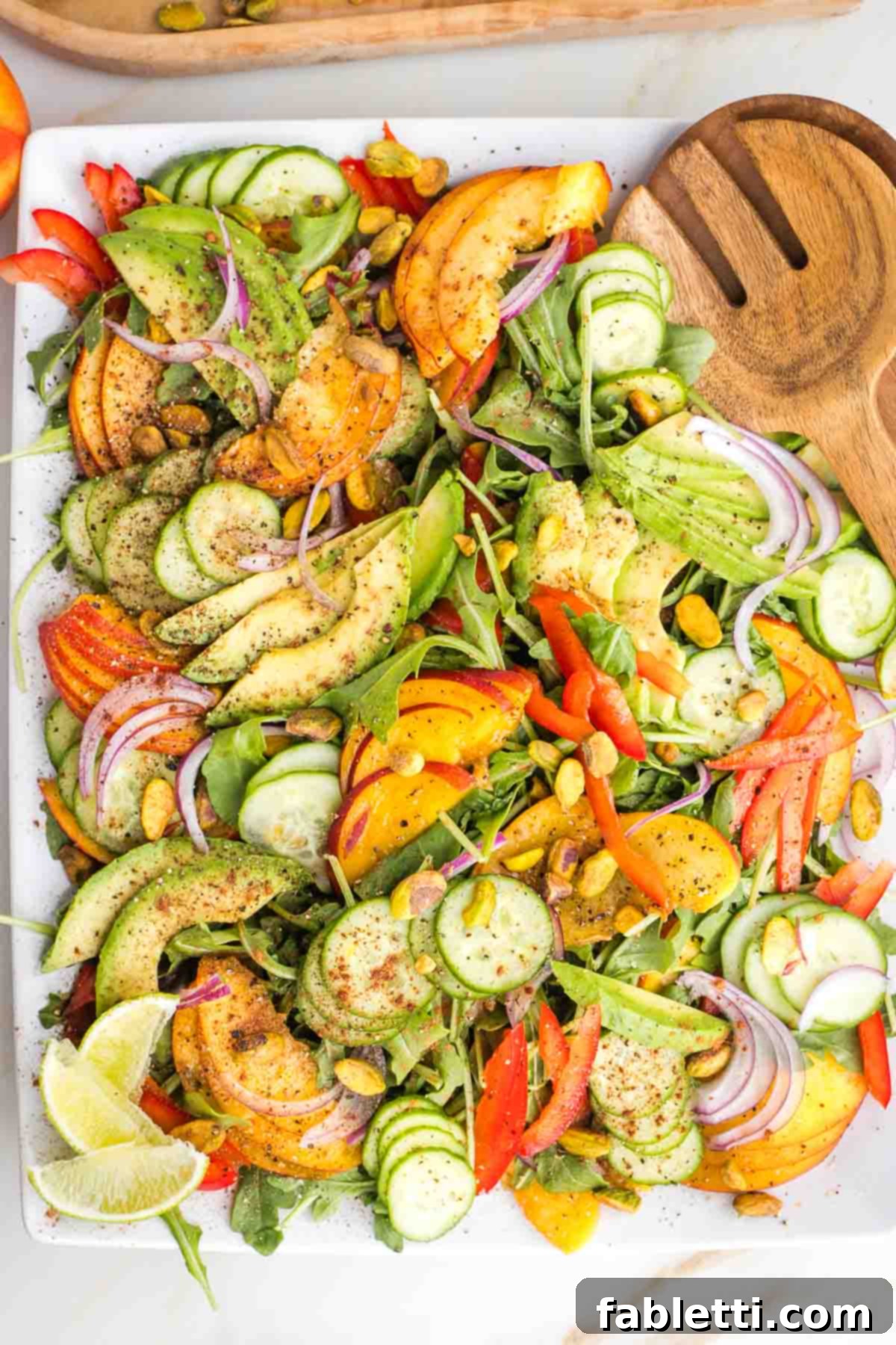 Vibrant Nectarine Arugula Salad 2 Vibrant Nectarine Salad with Arugula, sliced nectarines, avocados, cucumbers, red peppers and onions on a large platter.