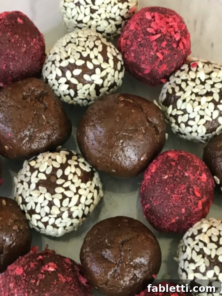 Sweet Halva Delights 2 Chocolate Halva bliss balls. Some coated with freeze dried raspberries and others with sesame seeds.