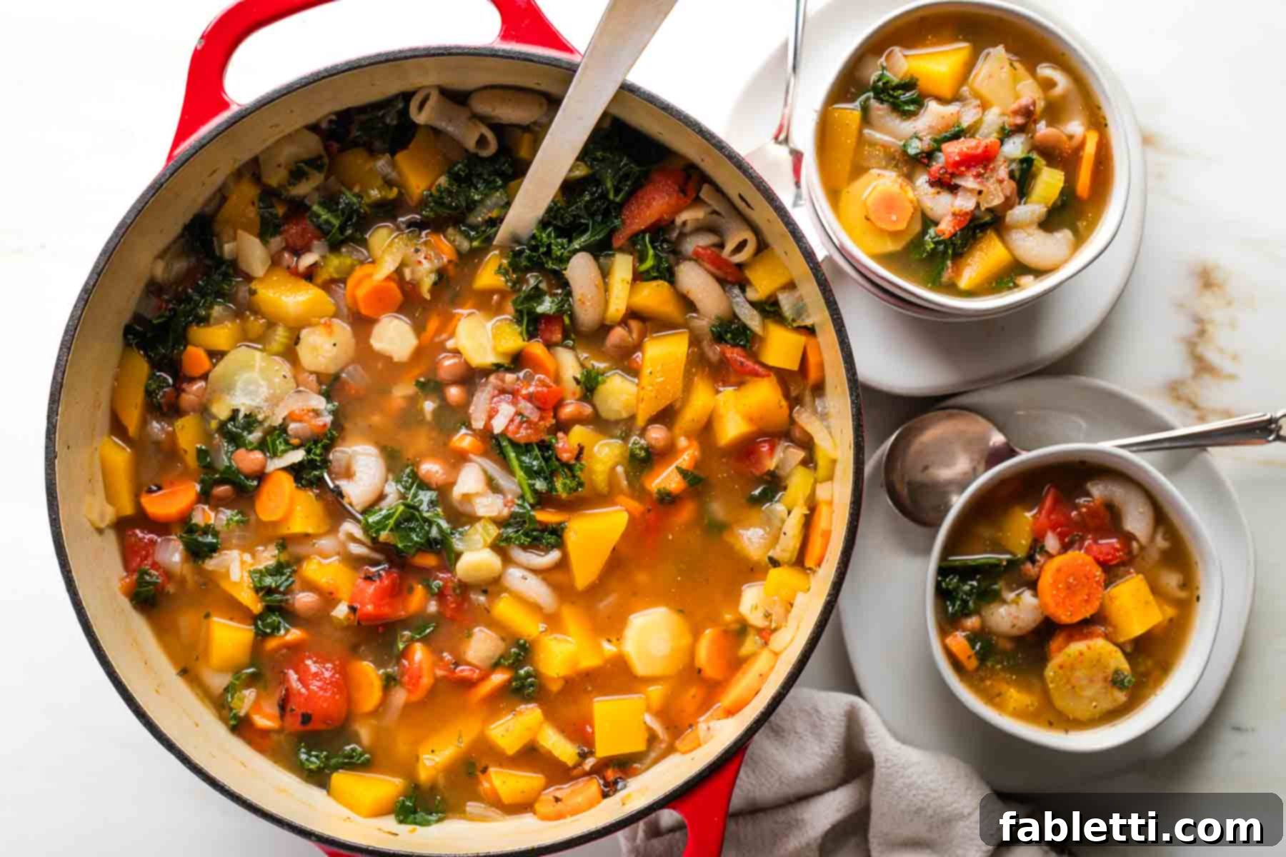 Hearty Fall Vegan Minestrone 13 Ladling chunky minestrone soup from a dutch oven into bowls.