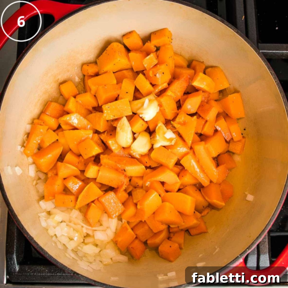 Velvety Vegan Butternut Bliss 15 Roasted butternut squash cubes, with garlic and onions in a dutch oven.