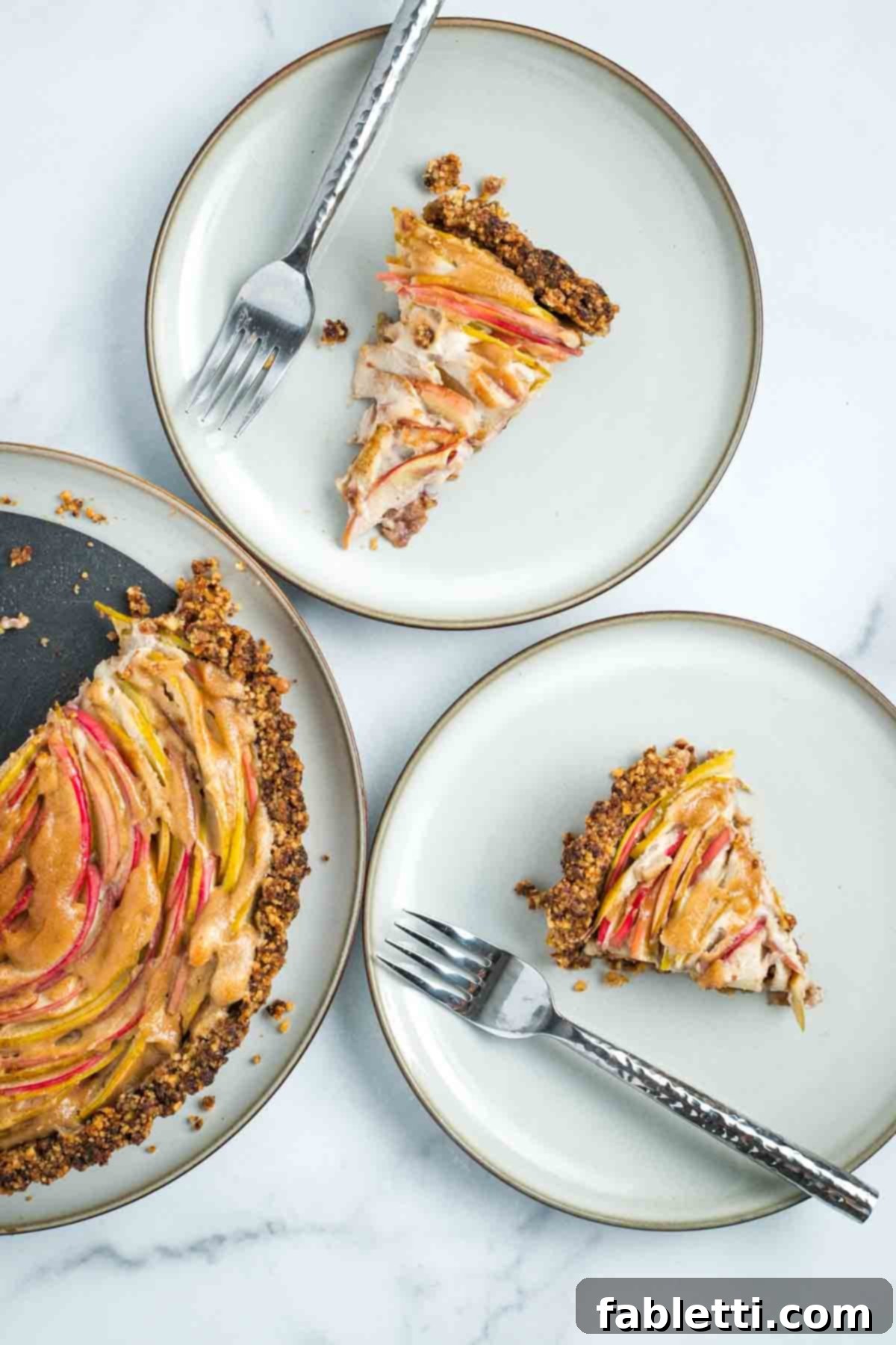 Nourishing Thanksgiving Feasts for 2025 5 Slices of apple tart with vegan custard and walnut date crust.