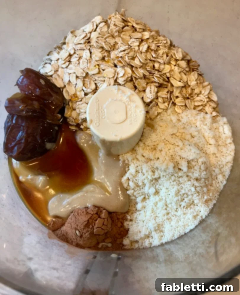 Energy-Packed Chocolate Oat Bars 4 Ingredients for the oatmeal base layer in a food processor: rolled oats, dates, tahini, almond flour, cacao powder, maple syrup.