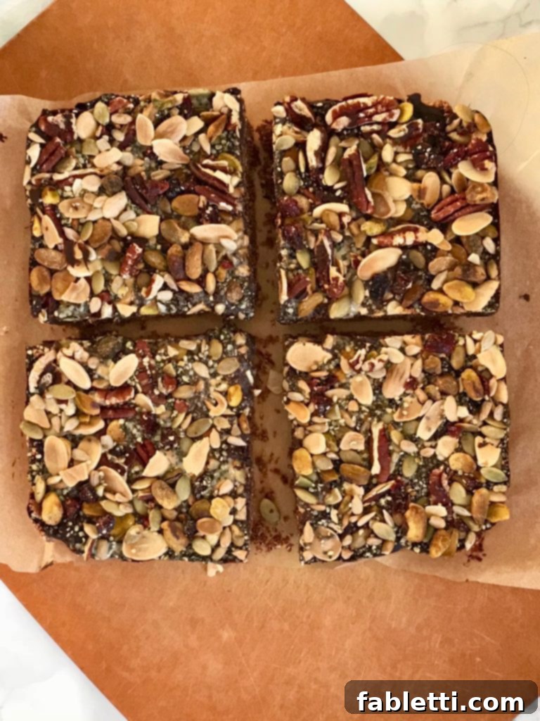 Energy-Packed Chocolate Oat Bars 7 Close-up of a single chocolate oatmeal trail bar, showing the layers and toppings.