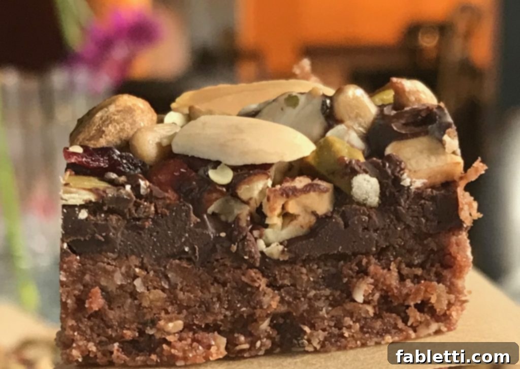 Energy-Packed Chocolate Oat Bars 8 Overhead shot of several chocolate oatmeal trail bars arranged neatly on a wooden cutting board.