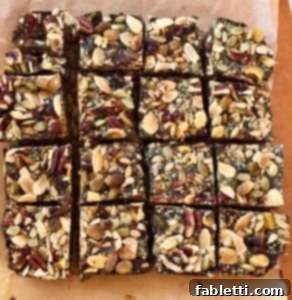 Energy-Packed Chocolate Oat Bars 9 A top-down view of a ready-to-eat chocolate oatmeal trail bar, showing its layers of oat base, chocolate, and nut-seed topping.