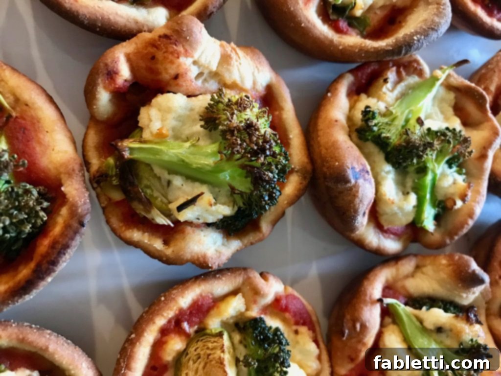 Pillowy Vegan Pizza Muffins with Ricotta Swirl 2 Savory vegan ricotta pizza muffins topped with roasted vegetables, a healthy and delightful snack or appetizer.