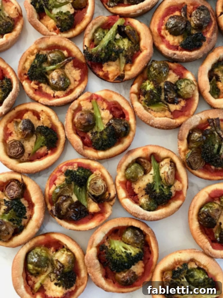 Pillowy Vegan Pizza Muffins with Ricotta Swirl 4 A tray of freshly baked vegan ricotta pizza muffins, showcasing their golden crust and colorful toppings.