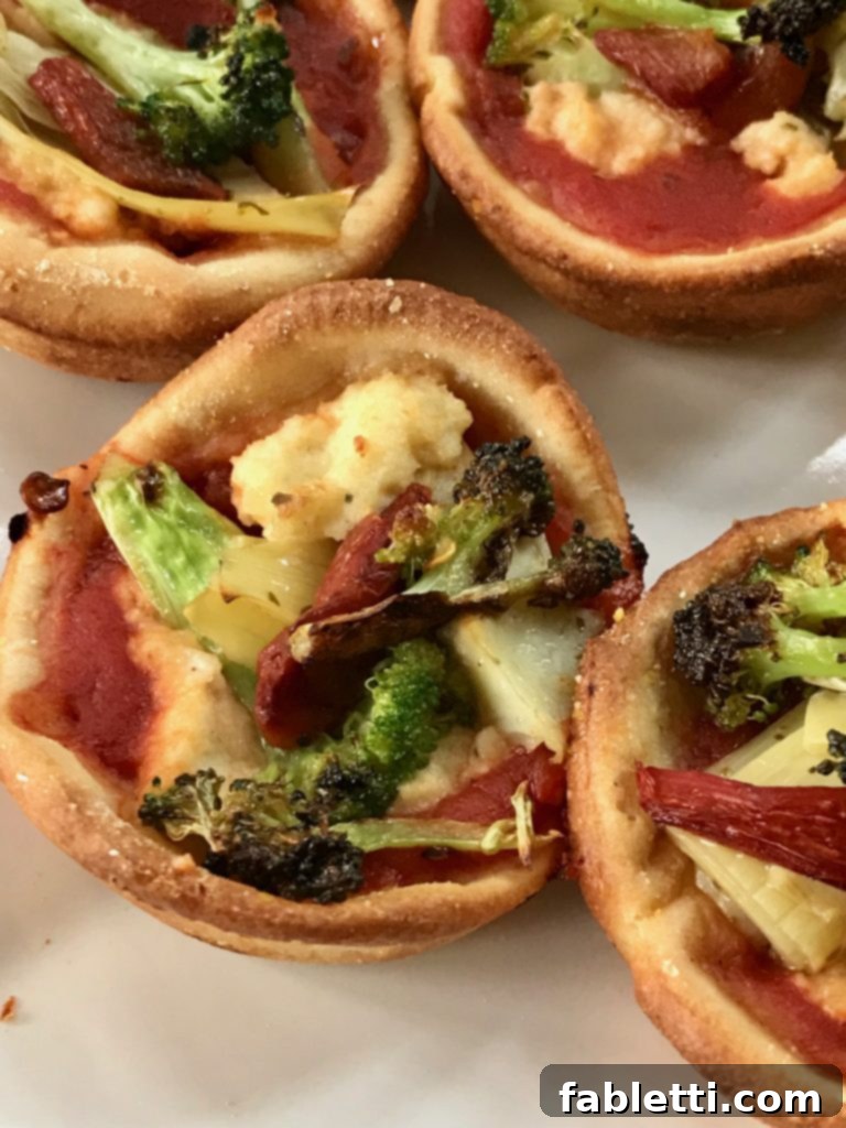 Pillowy Vegan Pizza Muffins with Ricotta Swirl 10 An overhead view of healthy vegan ricotta pizza muffins arranged on a rustic wooden board, garnished with fresh herbs.