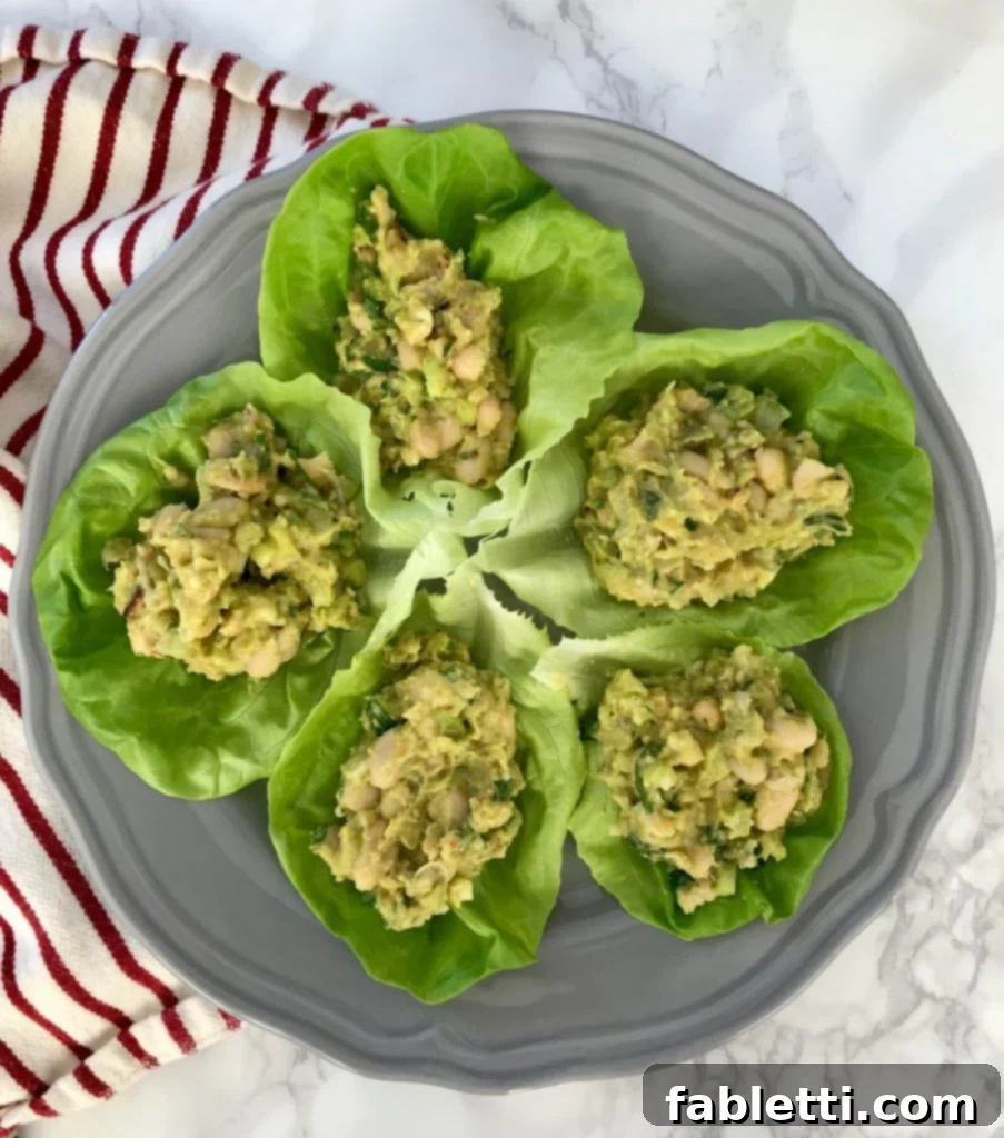 Creamy Vegan Chicken Salad 11 A large bowl of creamy vegan faux chicken salad, garnished with fresh herbs, ready to be served.