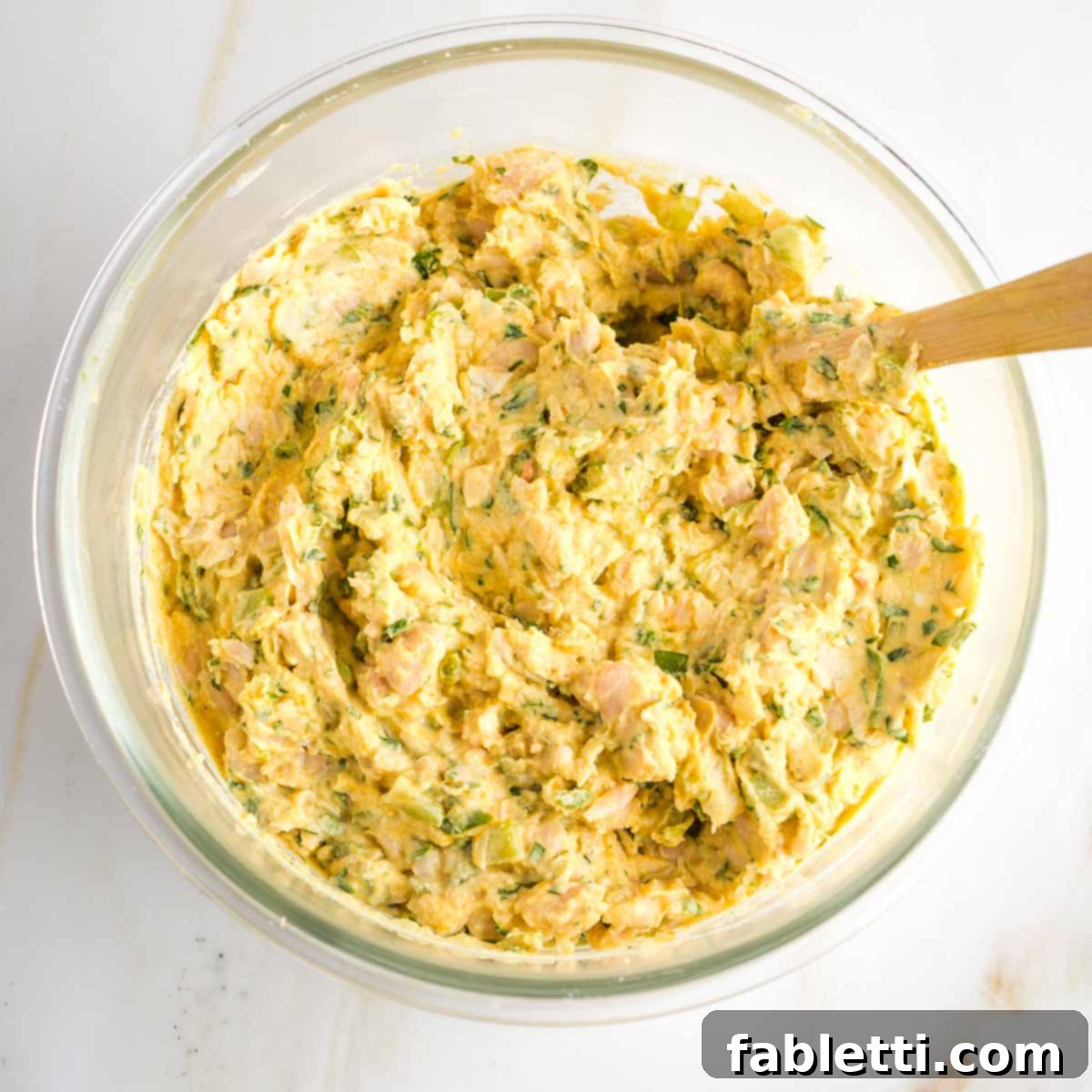 Creamy Vegan Chicken Salad 7 A glass bowl showcasing the finished vegan chicken salad, displaying its varied textures and creamy consistency, resembling traditional chicken salad.