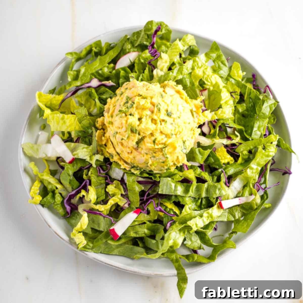Creamy Vegan Chicken Salad 8 Close-up of a serving of vegan chicken salad, showcasing its creamy texture and visible vegetable pieces, ready to be enjoyed.