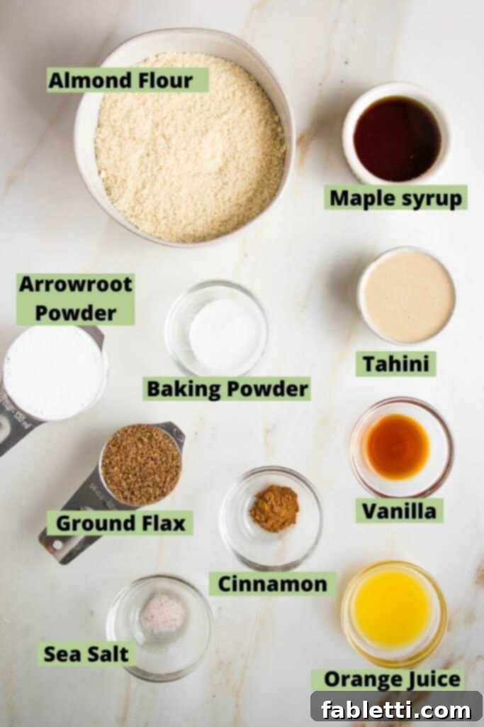 labeled ingredients for easy hamentashen recipe: almond flour, arrowroot powder, baking powder, ground flax, cinnamon, sea salt, maple syrup, tahini, vanilla, and orange juice.