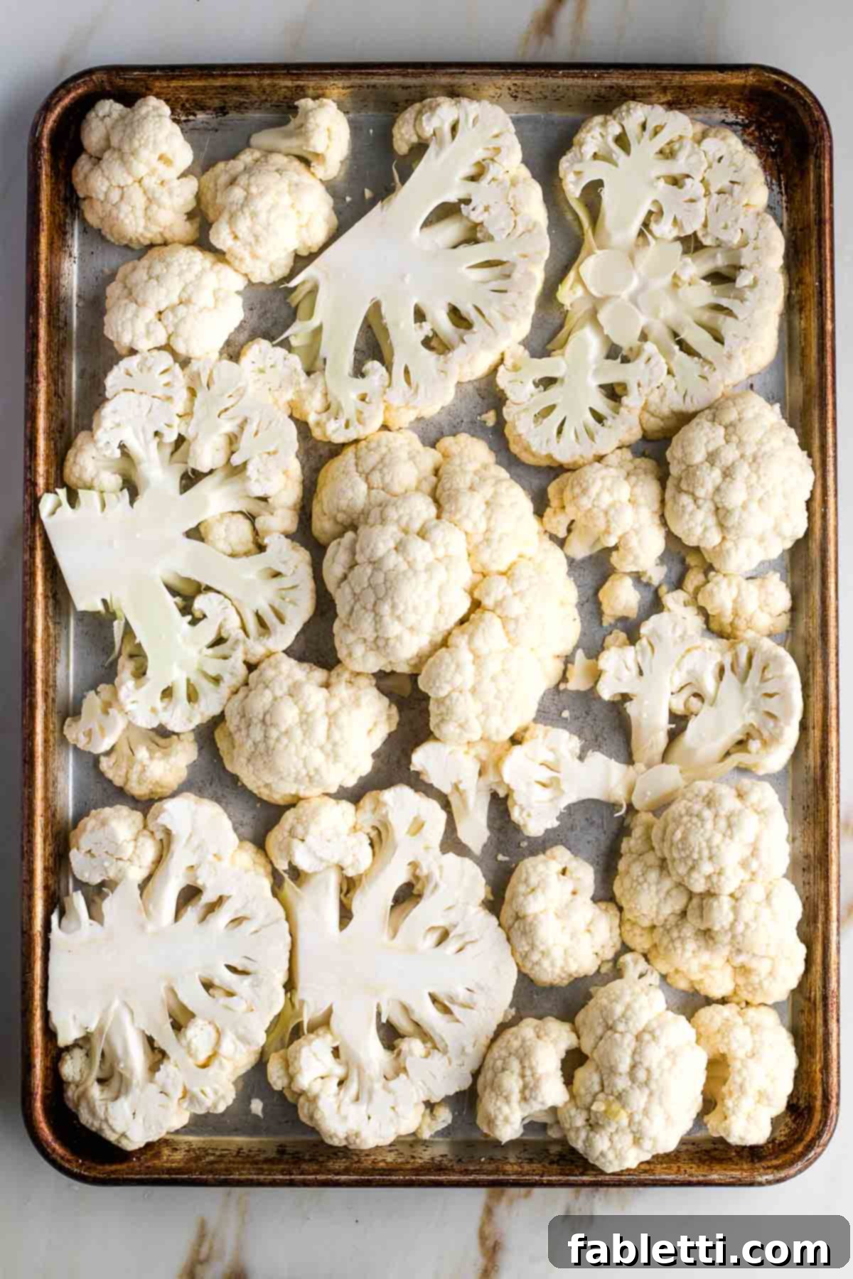 Golden Seared Cauliflower Steaks with Herbaceous Chimichurri 10 Large rimmed baking sheet with cauliflower steaks in a single layer.