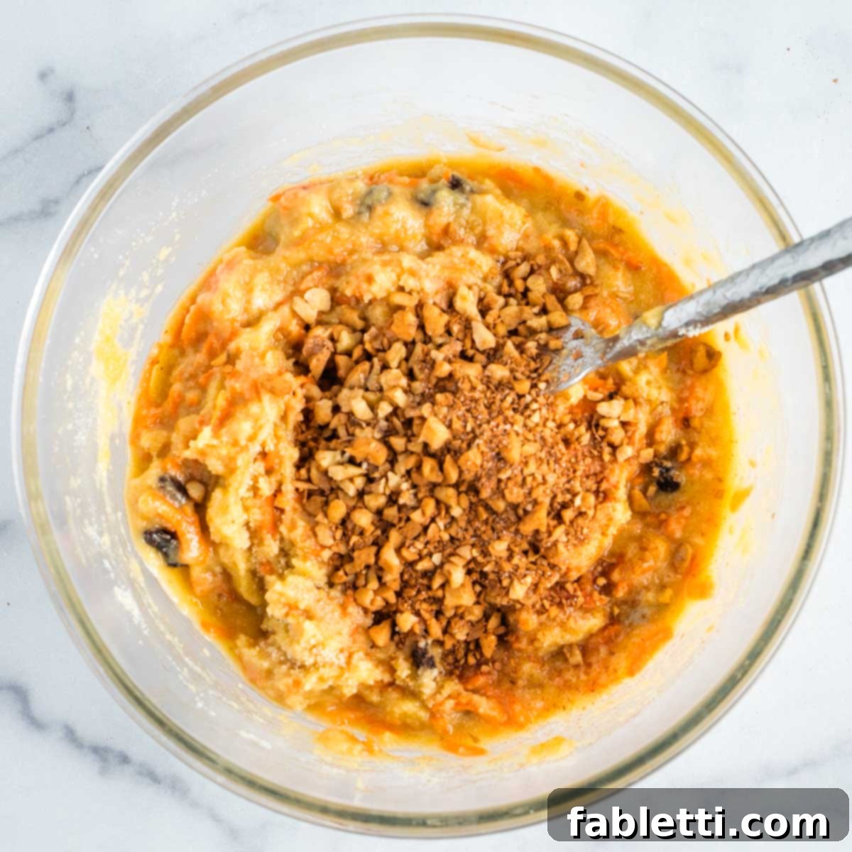 Delightful Gluten-Free Almond Carrot Muffins 11 Adding walnut and cinnamon mixture to the muffin batter, reserving some for topping.