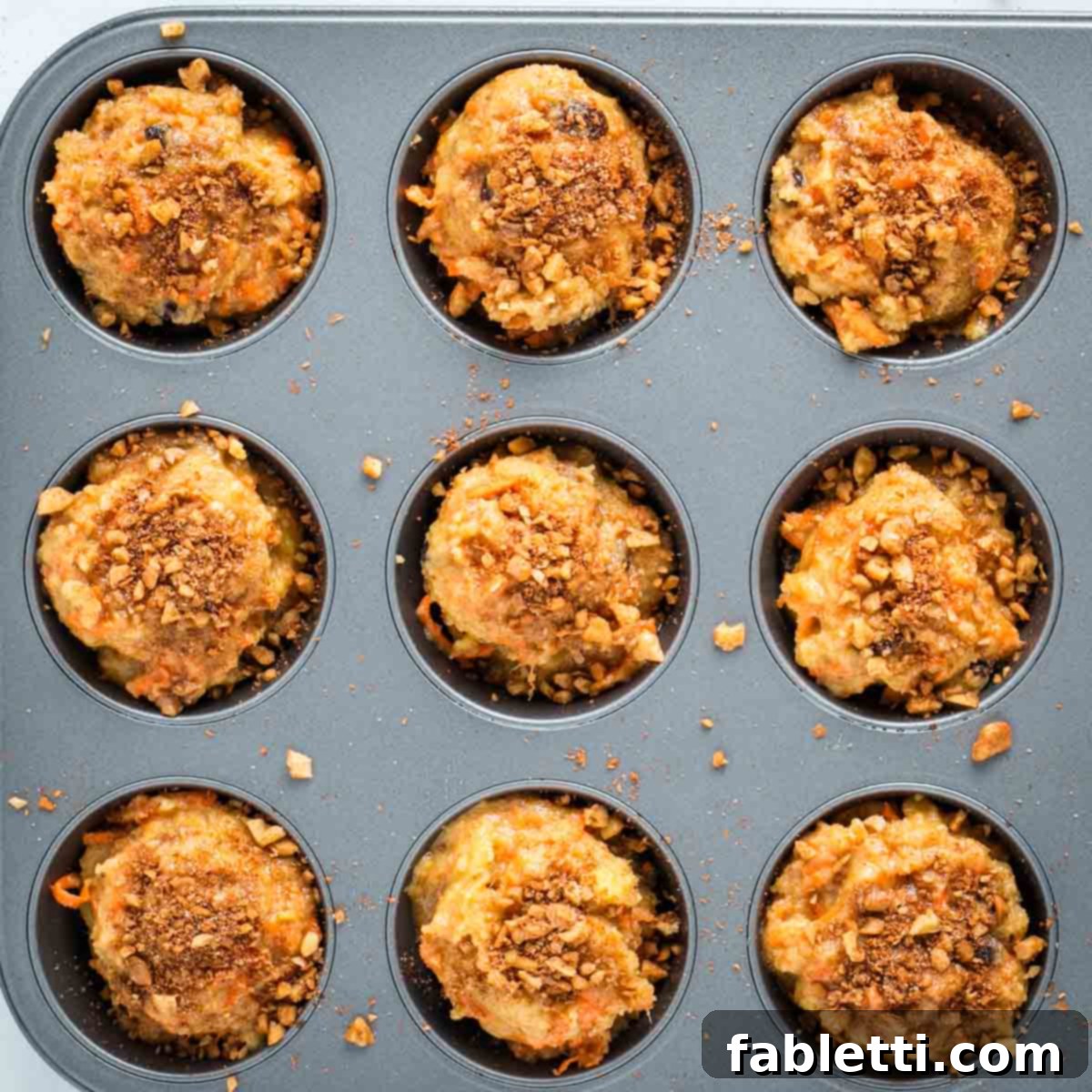 Delightful Gluten-Free Almond Carrot Muffins 13 Sprinkling the reserved walnut and cinnamon mixture on top of muffin batter in tins.