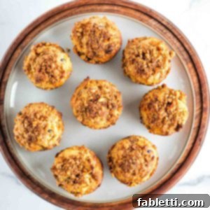 Delightful Gluten-Free Almond Carrot Muffins 17 Round plate filled with carrot muffins with walnuts, raisins and shredded carrots.