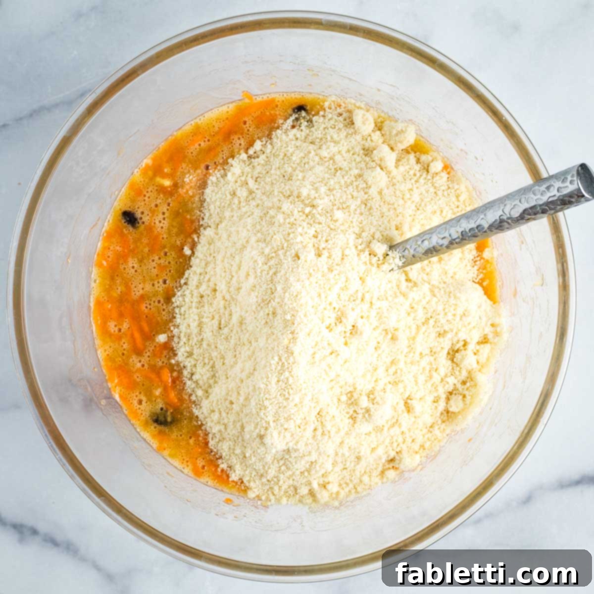 Delightful Gluten-Free Almond Carrot Muffins 9 Stirring almond flour into the muffin batter.