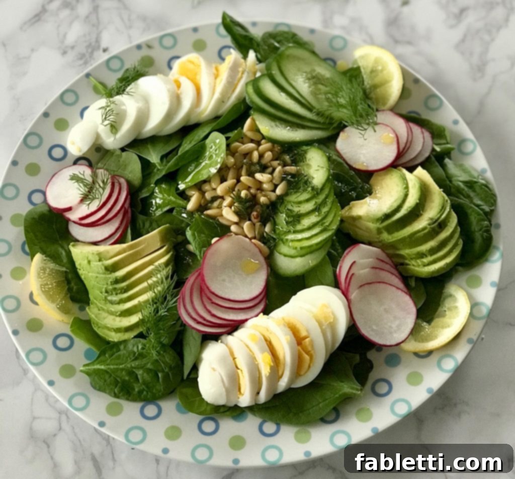 A balanced Simple Spinach Salad platter featuring protein, carbohydrates, and healthy fats from eggs, avocado, spinach, and nuts