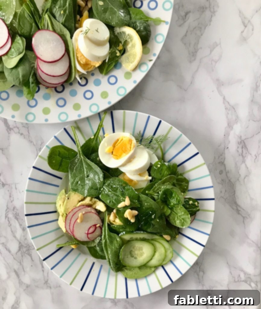 A serving of Simple Spinach Salad, illustrating an entire healthy and satisfying meal on one plate