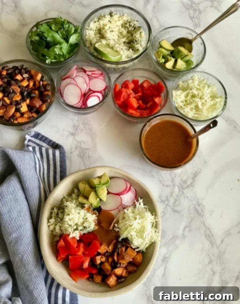 Plant-Powered Enchilada Bowls 2 A colorful enchilada bowl surrounded by small dishes of its fresh ingredients: homemade enchilada sauce, various chopped vegetables, roasted sweet potatoes, and black beans.