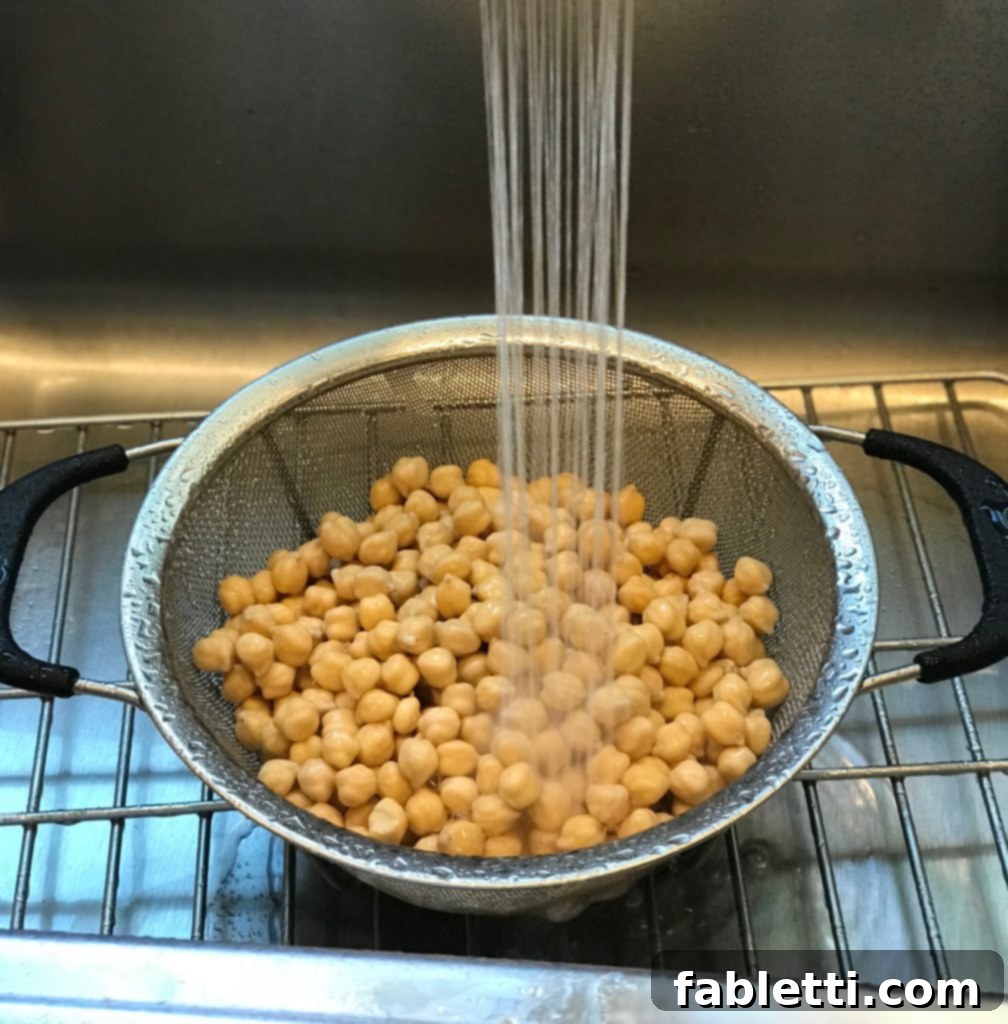 Close-up of creamy oil-free hummus with a spoon, highlighting its smooth texture.