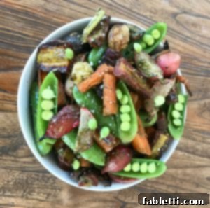 Roasted Vegetables with Carrot Top Pesto 10 Snap peas, carrots, radishes in a white bowl.