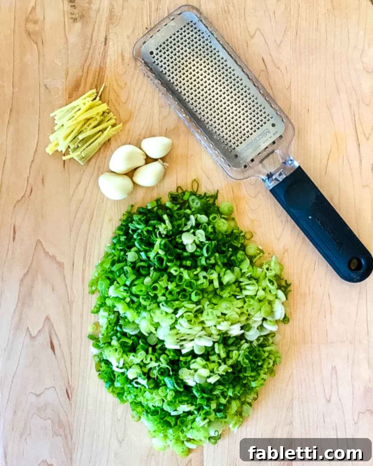 Aromatic Ginger Scallion Baby Bok Choy 3 Thinly sliced scallions, cloves of garlic and pieces of ginger plus a microplane grater.