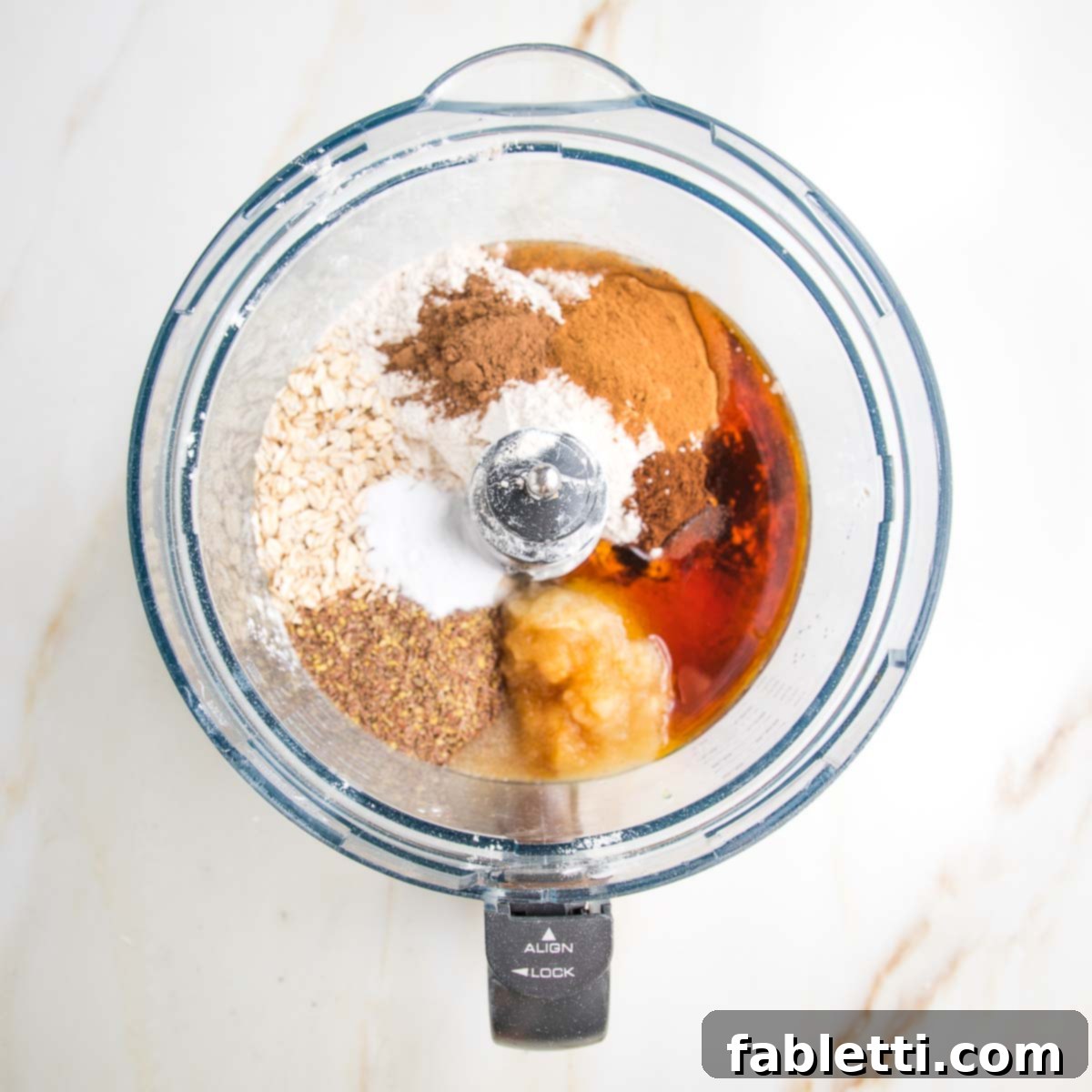 Spiced Apple Bundt Delight 5 Ingredients in a food processor bowl: flours, ground flax, baking powder, maple syrup.