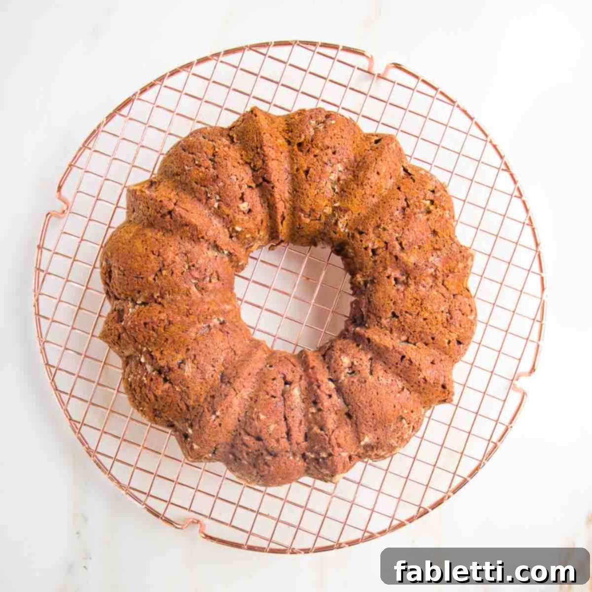 Spiced Apple Bundt Delight 10 Apple bundt cake cooling on a circular wire rack.