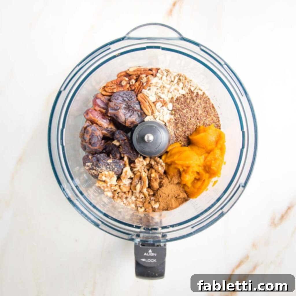 Pumpkin Spice Truffles 7 All the core ingredients for pumpkin balls — including pumpkin puree, dates, nuts, ground flax seeds, rolled oats, vanilla, and spices — are added together into the bowl of a food processor.