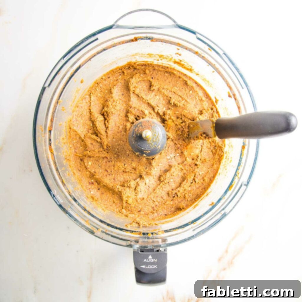Pumpkin Spice Truffles 8 The food processor bowl, containing a well-mixed pumpkin mixture, exhibiting a slightly textured consistency.