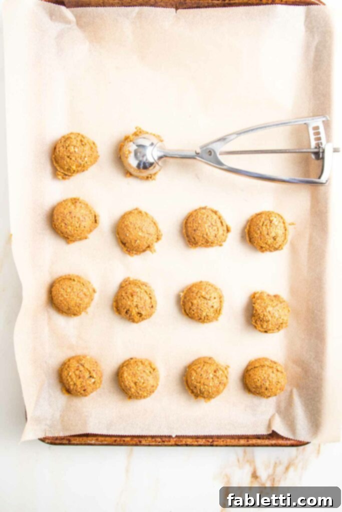 Pumpkin Spice Truffles 9 A small cookie scoop is used to portion out uniform amounts of the pumpkin mixture, preparing them for rolling into balls.