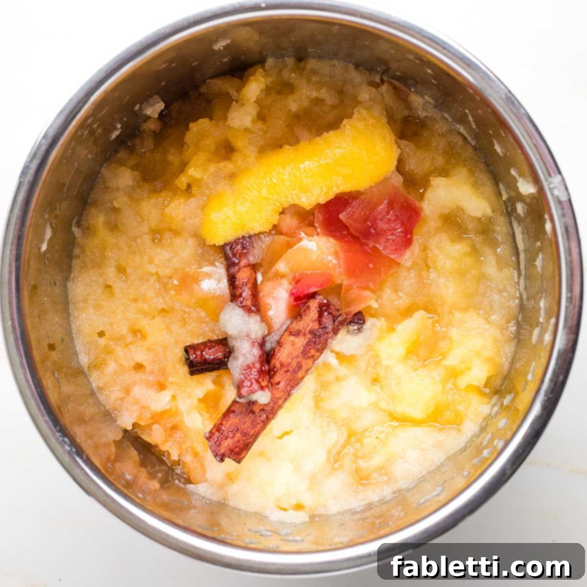 Cooked applesauce in an Instant Pot, ready to be mashed.