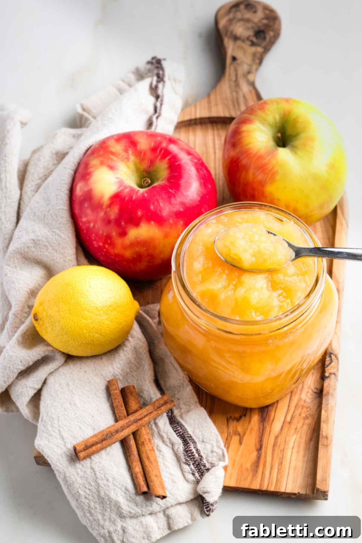 Jars of homemade applesauce, ready for storage.