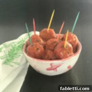 Vegan Sweet and Sour Meatballs in a small dish with colorful toothpics.